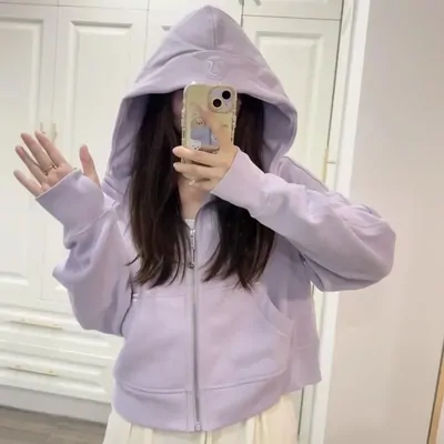 A lilac zip-up hoodie worn with the hood up, shot in a mirror.